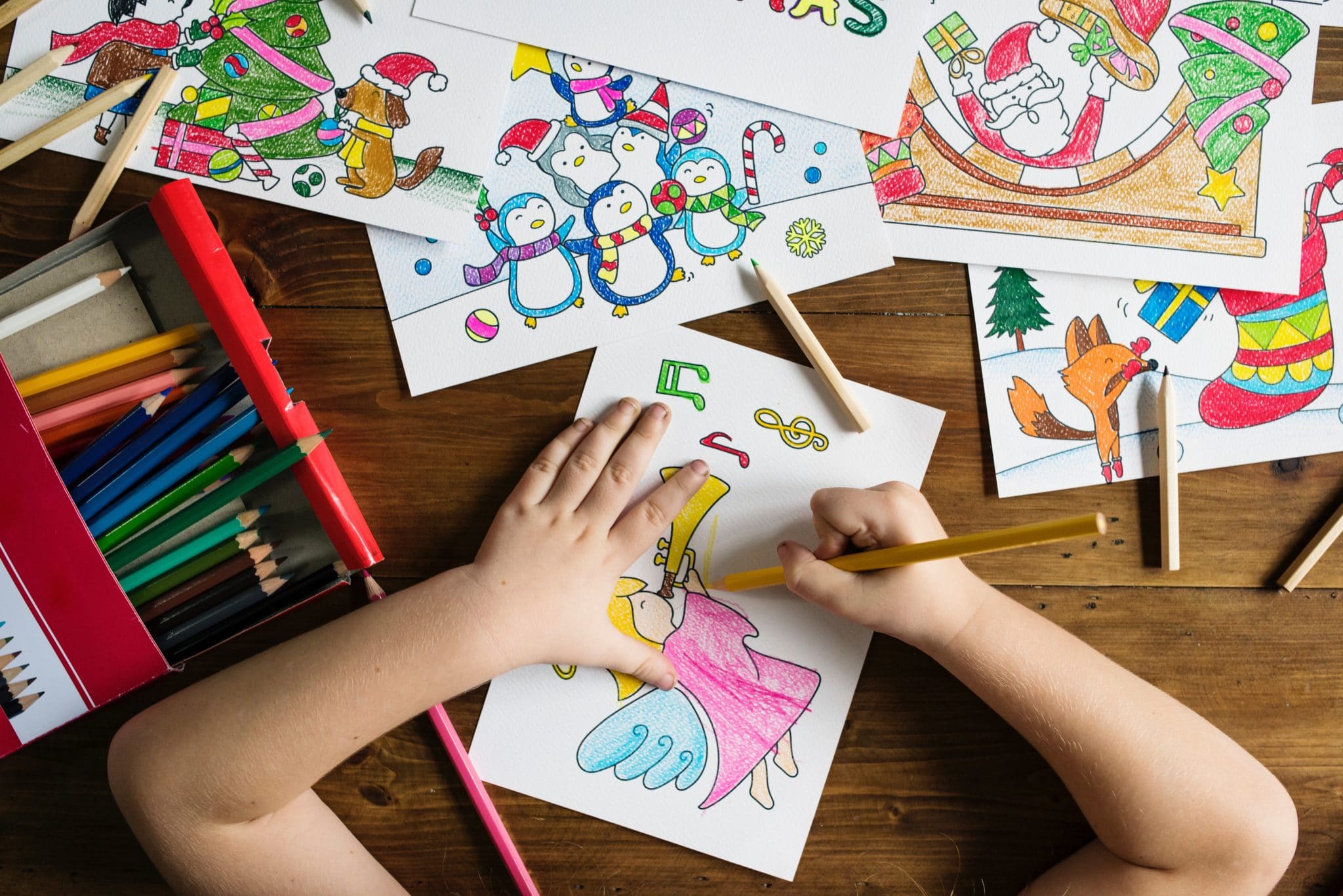 child coloring with map pencils - holiday