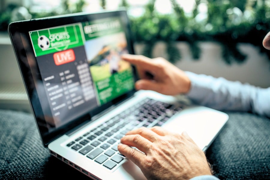 Watching football match on computer and betting
