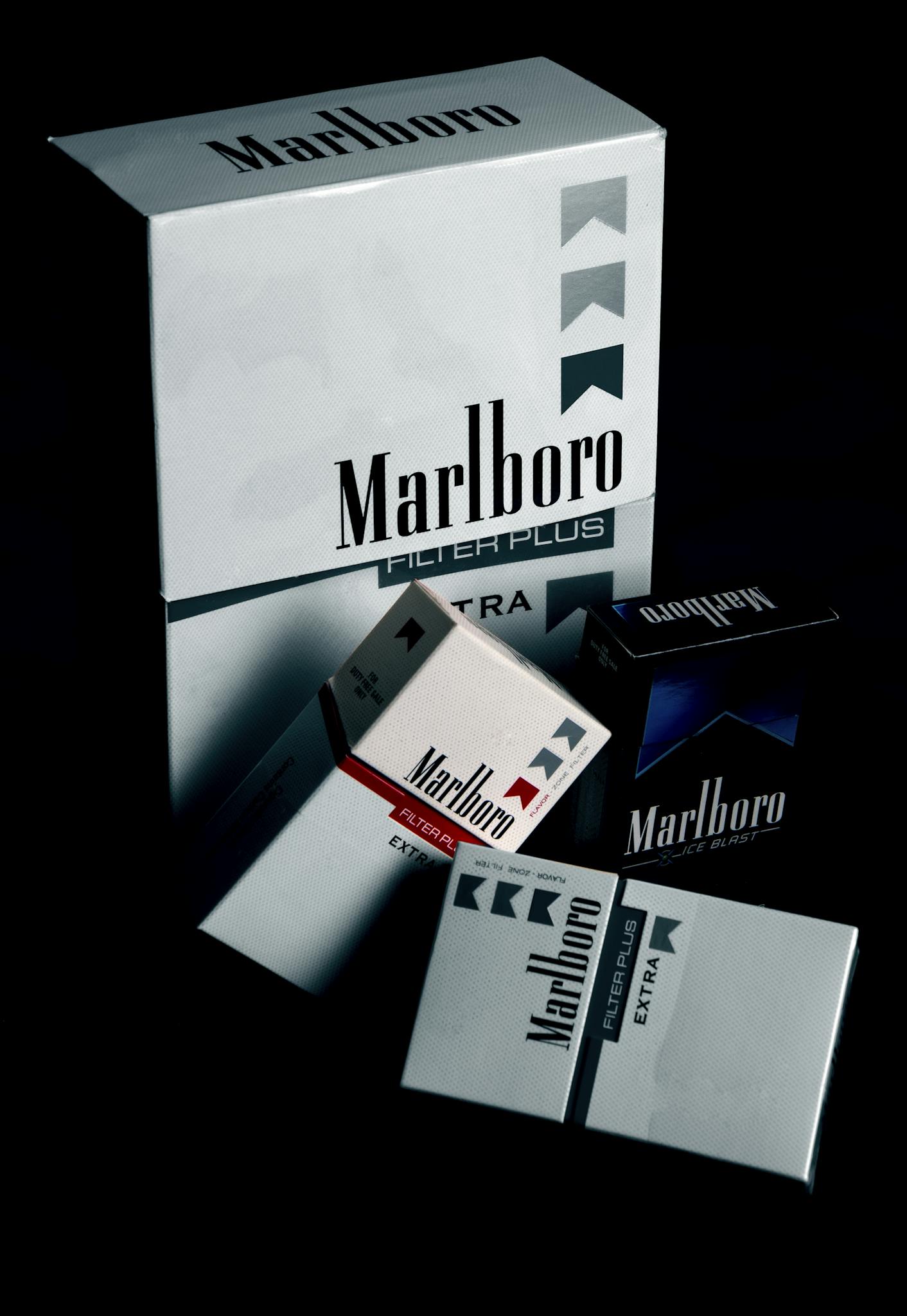 Cigarette Brands -Collection of Marlboro cigarette packs displayed on a black surface, highlighting brand design.