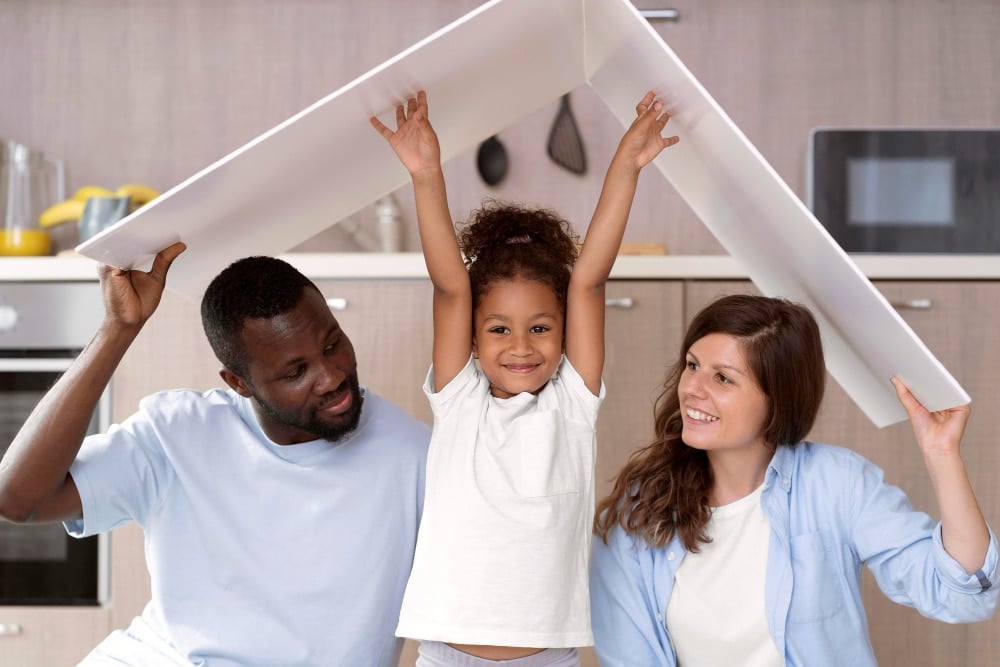 Cute family holding a roof above their head