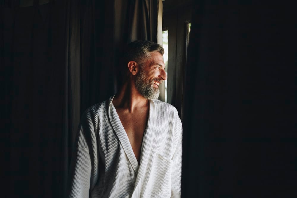Cheerful man in a bathrobe - silver fox man