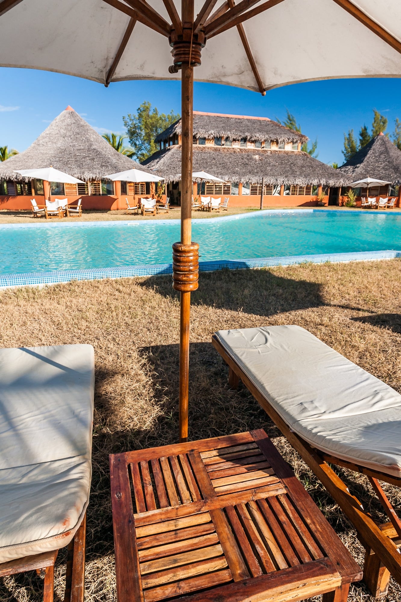 Sunbed and swimmin pool in a tropical resort