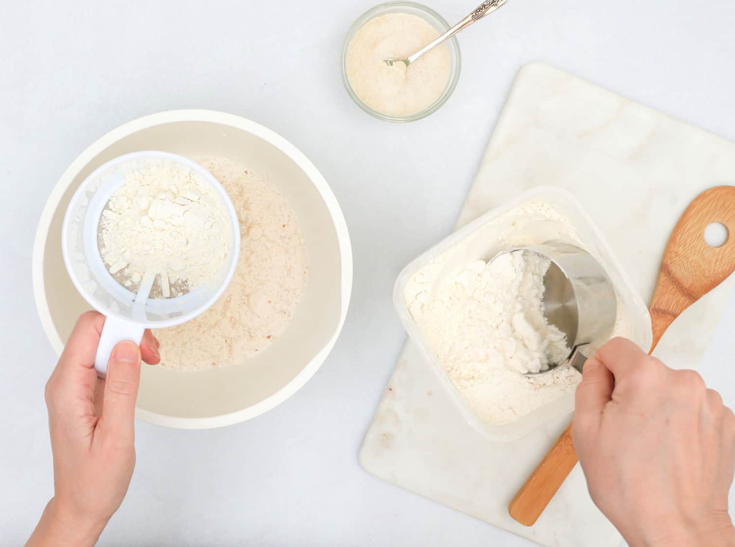 Mixing yeast starter and flour in a bowl. Step by step bread dough recipe, close upview from above, woman hands