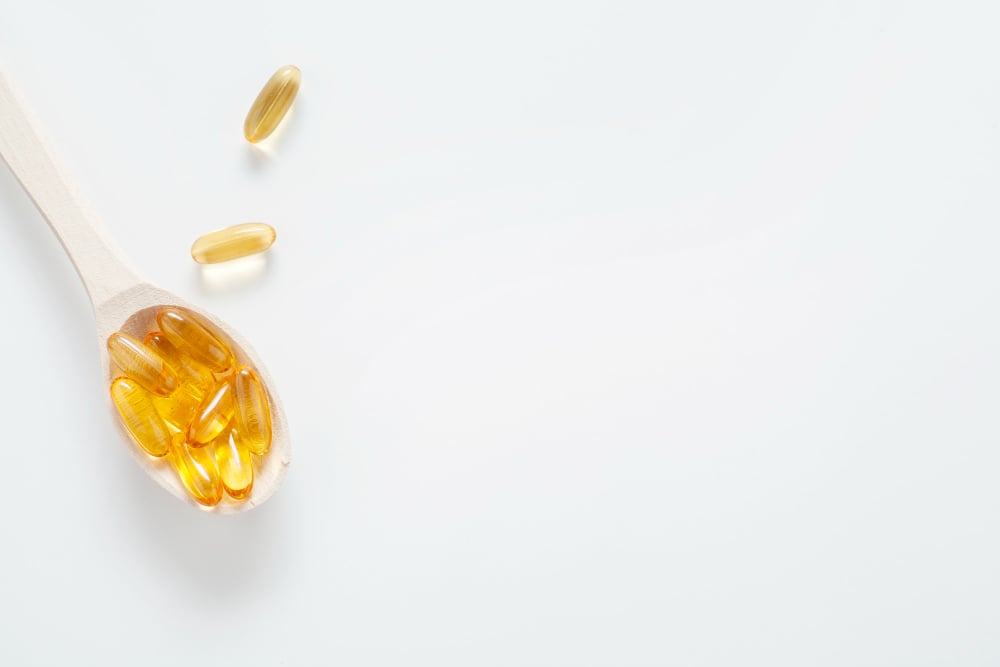 Fish oil capsules on a spoon
