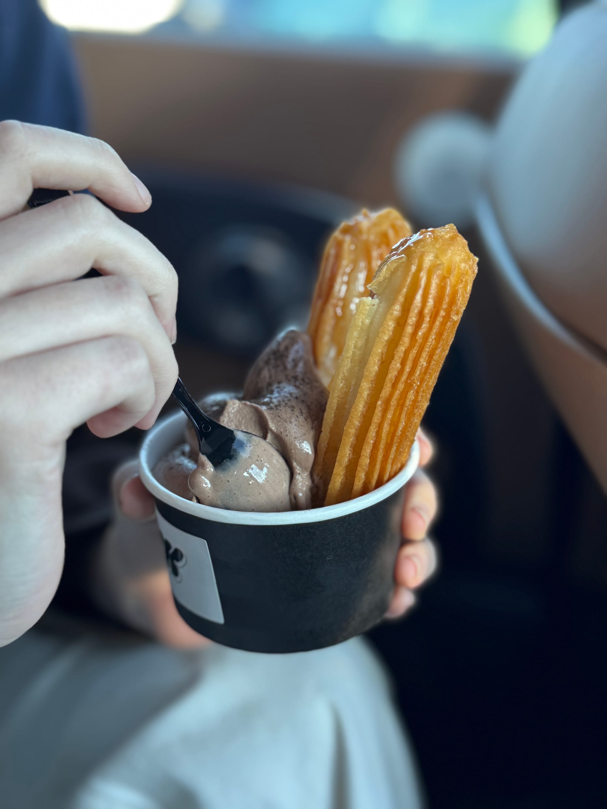 Chocolate mochi churro paired with chocolate soft serve from IYKYK Mochi Churros in Dallas, showing the crispy exterior and chewy mochi center.