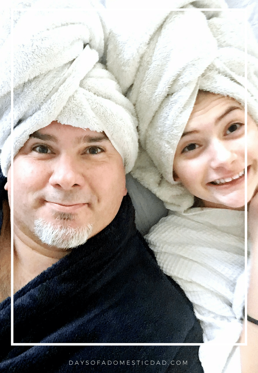 Dad and Daughter wearing bath towels on their heads.