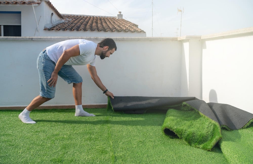 Man installing artificial grass