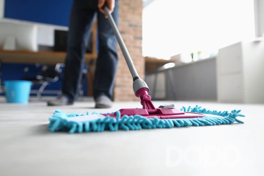 Man with mop washes floor