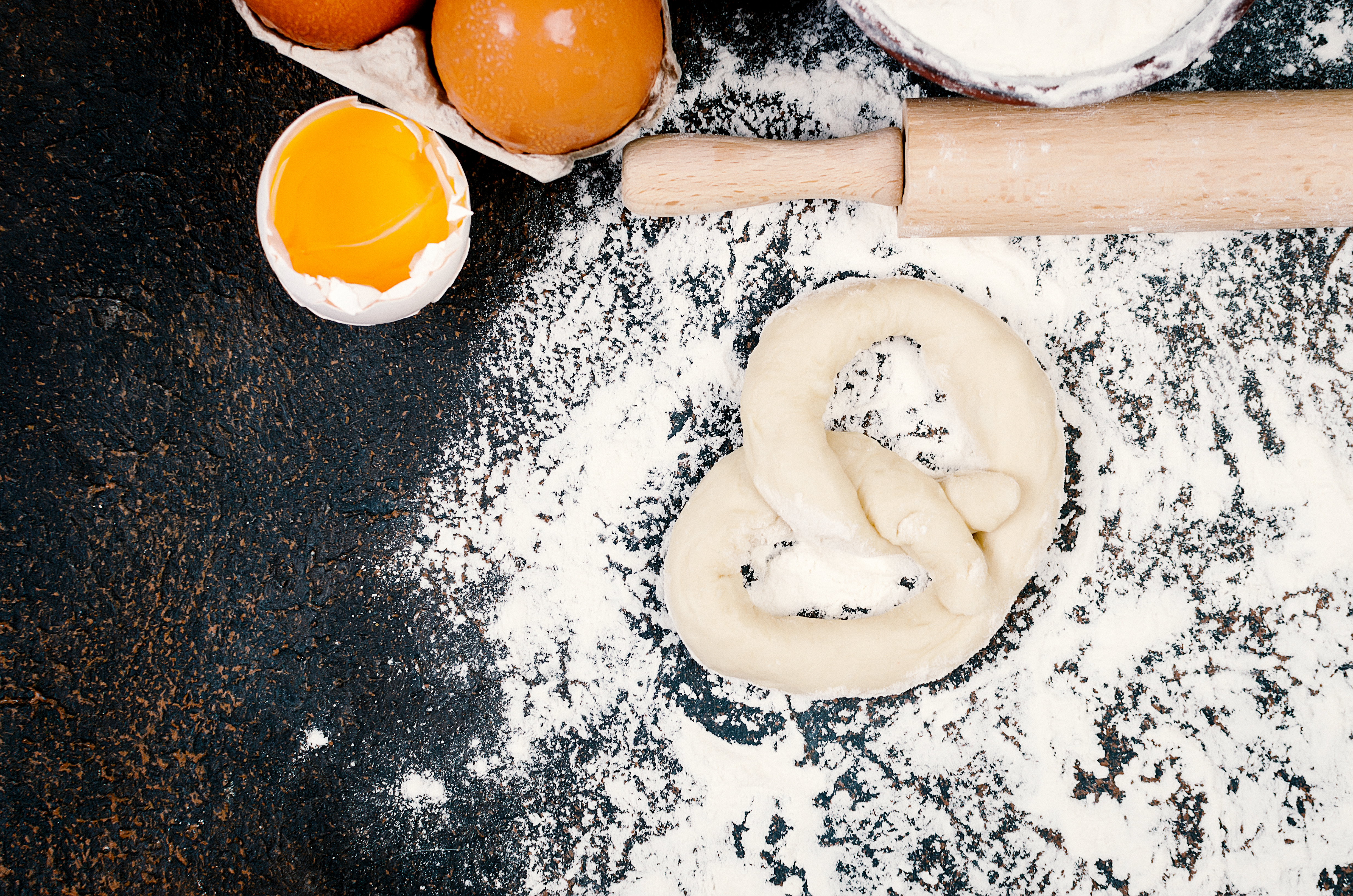 Fresh homemade pretzels dough on a hard surface.