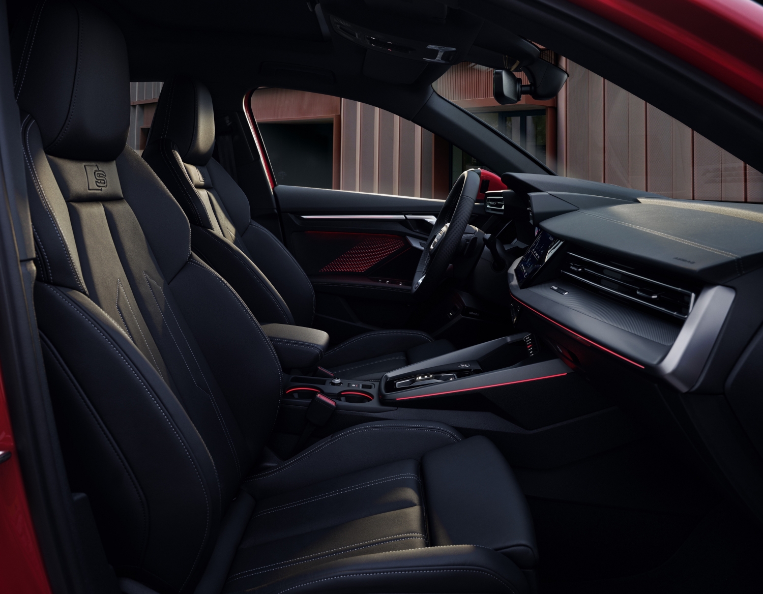 2025 Audi A3 interior with black leather sport seats and red ambient lighting