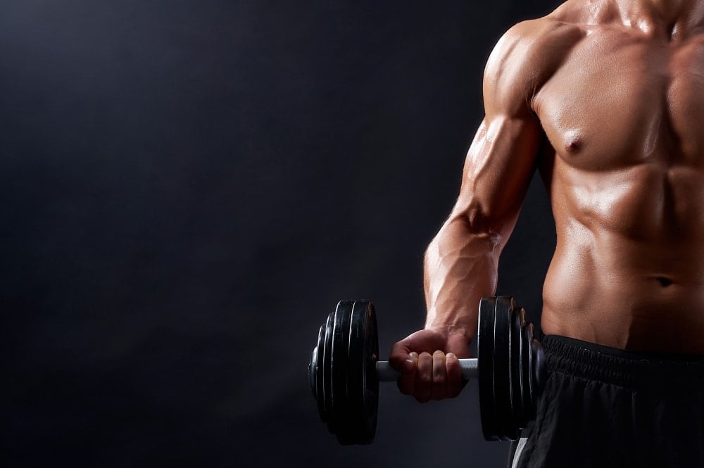 Young male workout lifting weights