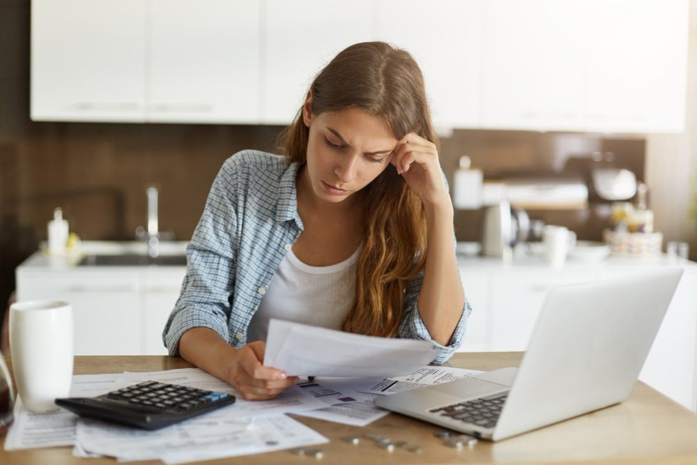 Free photo young woman checking her budget and doing taxes