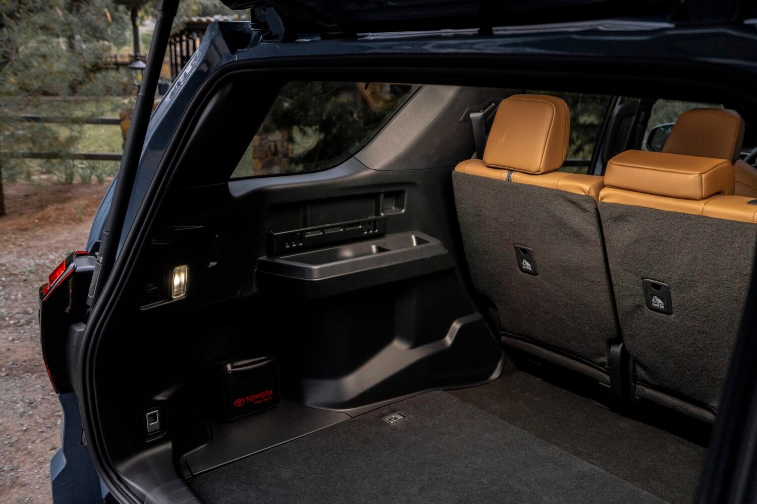 The interior of a Toyota 4Runner featuring premium brown leather-trimmed seats and a 14-inch multimedia touchscreen, perfect for comfortable family road trips.