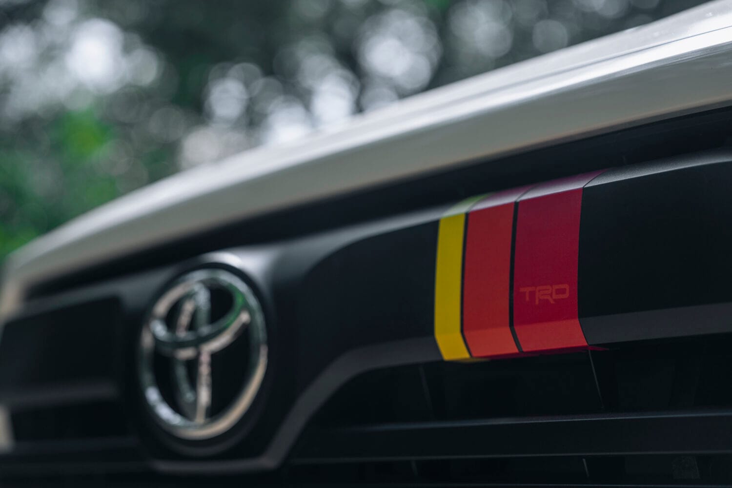 Front grille detail of the 2026 Toyota Tundra TRD Rally with signature red, orange, and yellow stripes