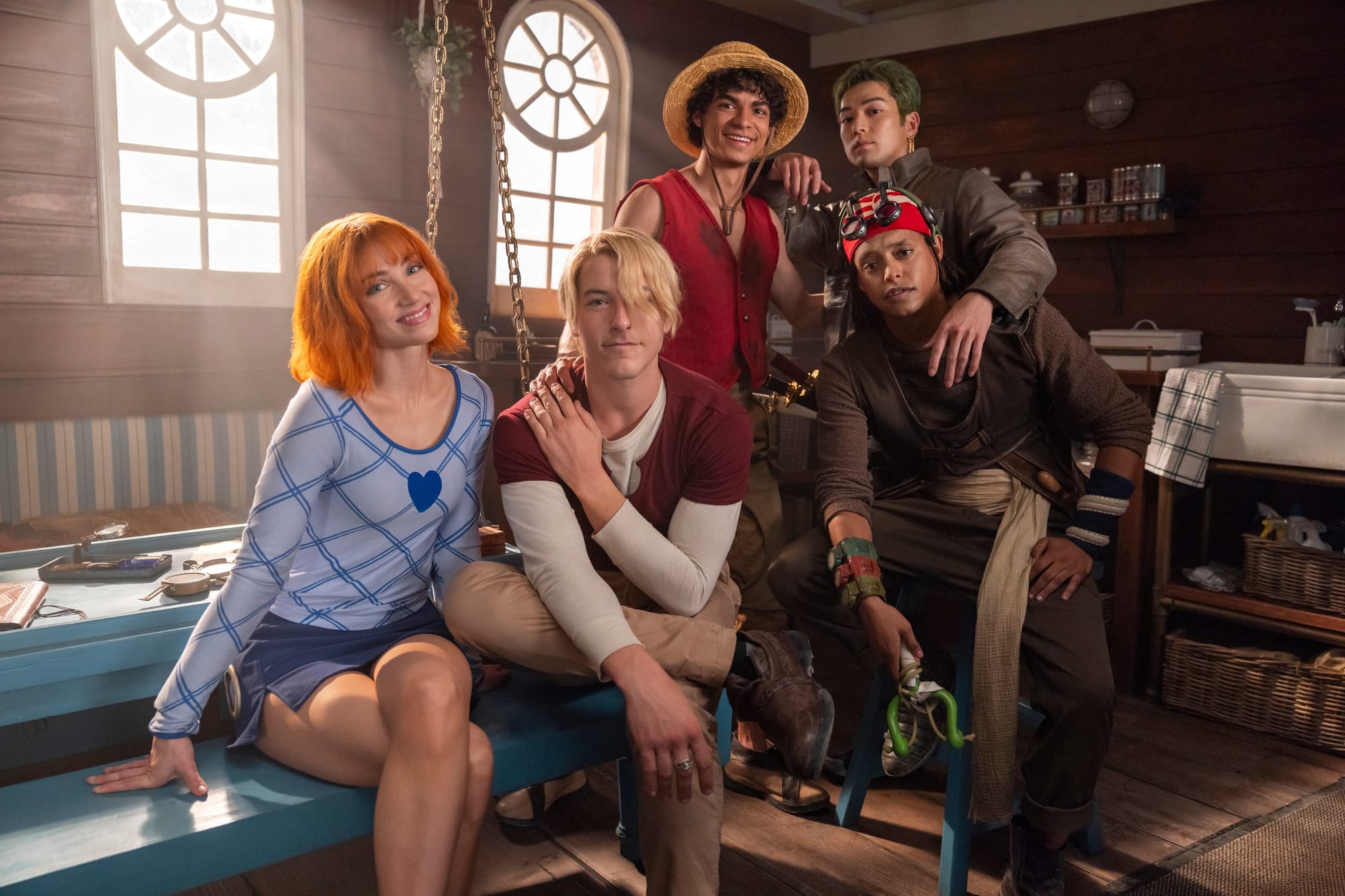 Cast of One Piece Season 2 on Netflix in a group scene inside a ship cabin ahead of the March 2026 premiere.