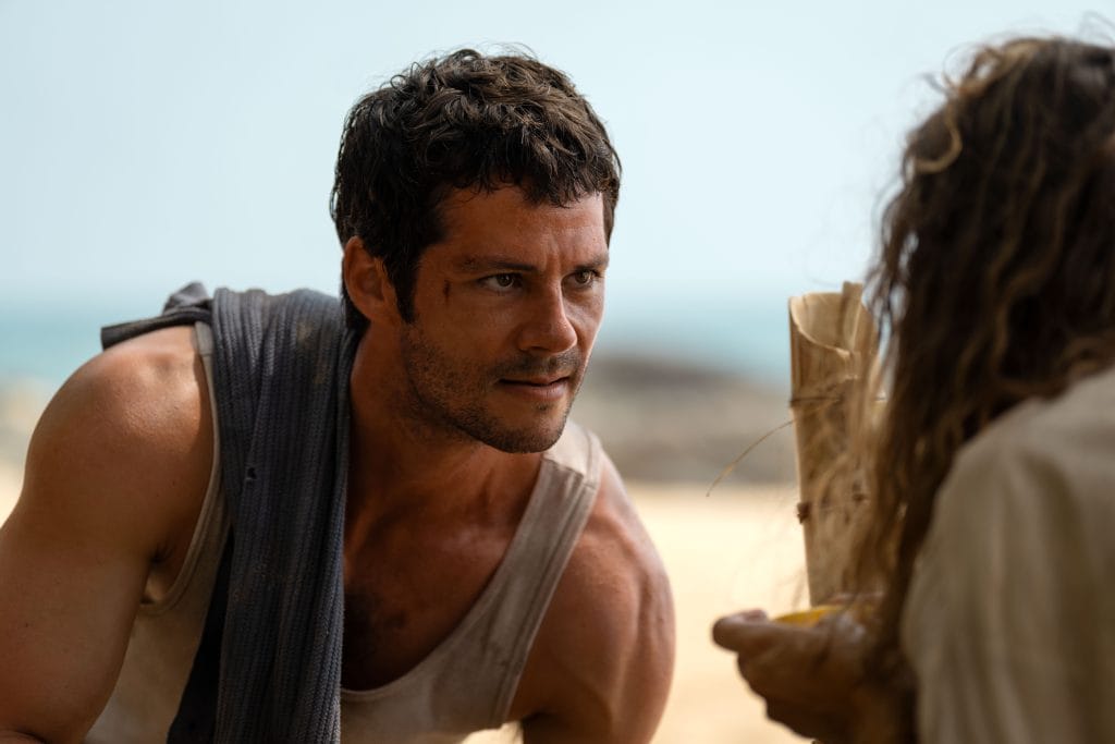 Bradley Preston speaks with Linda Liddle during an intense moment on the island in Send Help (2026)