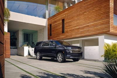 The 2023 Suburban High Country front three-quarter view parked.