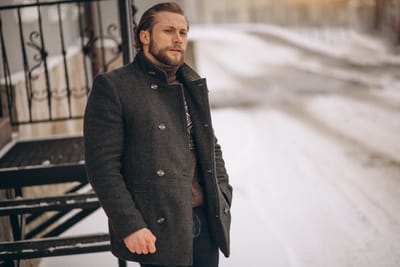 Bearded man posing in the street in winter