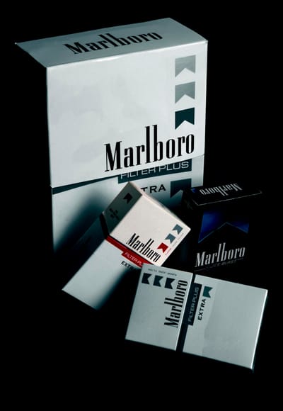 Cigarette Brands -Collection of Marlboro cigarette packs displayed on a black surface, highlighting brand design.