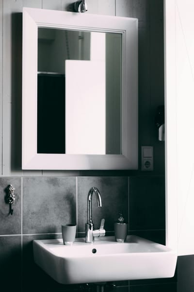 Contemporary bathroom showcasing a sleek sink and framed mirror, perfect for modern interior designs.