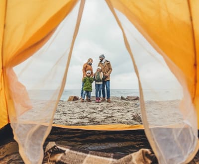 Family of four camping near the beach