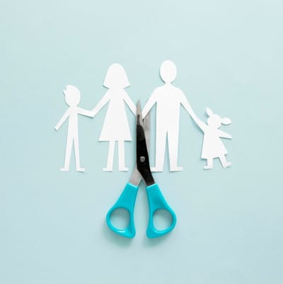 Paper family being cut in half with scissors - divorce
