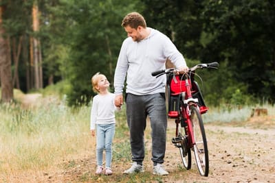 Front view father and daughter walking
