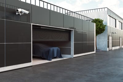 Modern garage with CCTV security camera and a car under cover