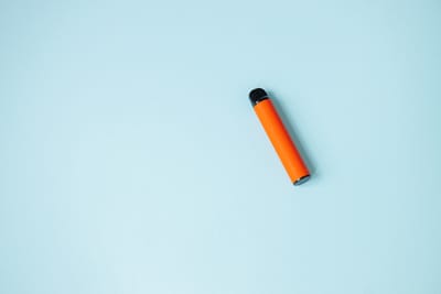 One disposable orange ecigarettes concept of bad habits modern smoking electronic cigarettes