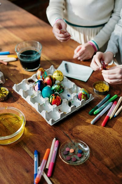 Vibrant Easter egg decoration scene with kids painting creatively indoors.