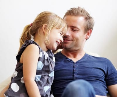 dad and daughter laughing together during summer family time creating happy memories
