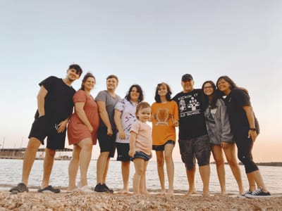 large family standing together on the beach showing strong family bond and parenting journey
