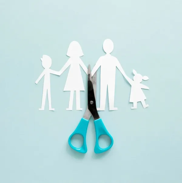 Paper family being cut in half with scissors - divorce