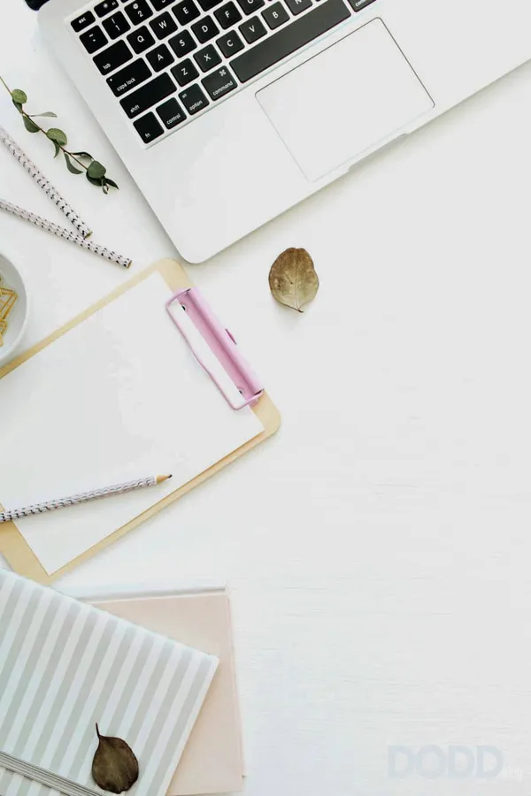 Flat lay home office desk workspace with laptop, notebook and clipboard on white background. Top view minimal mock up templat