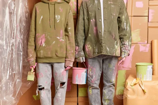 Cropped shot of dirty woman and man work as team holds paint bucket brushes painting house after relocation wear casual cloth