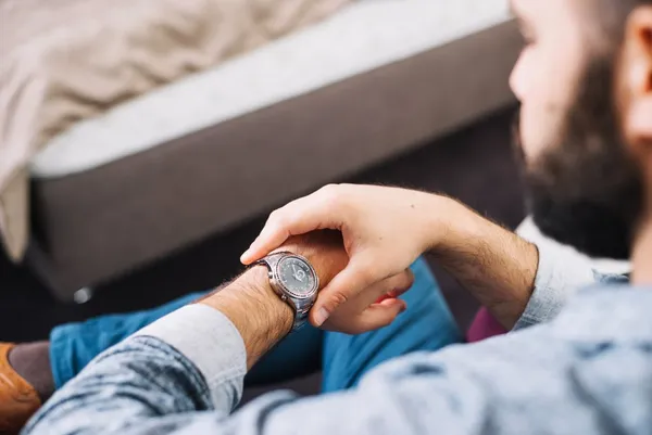 Free photo man checking time on wrist watch