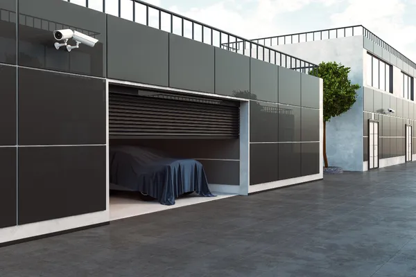Modern garage with CCTV security camera and a car under cover