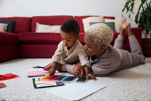 mother and son drawing on the floor