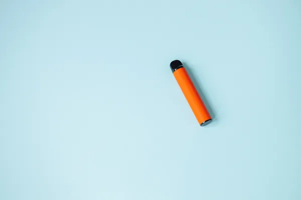 One disposable orange ecigarettes concept of bad habits modern smoking electronic cigarettes