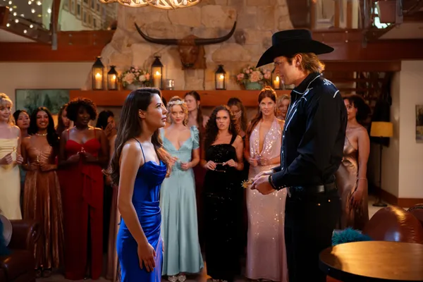 Dawn and Trey facing each other during a rose-style ceremony while contestants look on in The Wrong Paris.