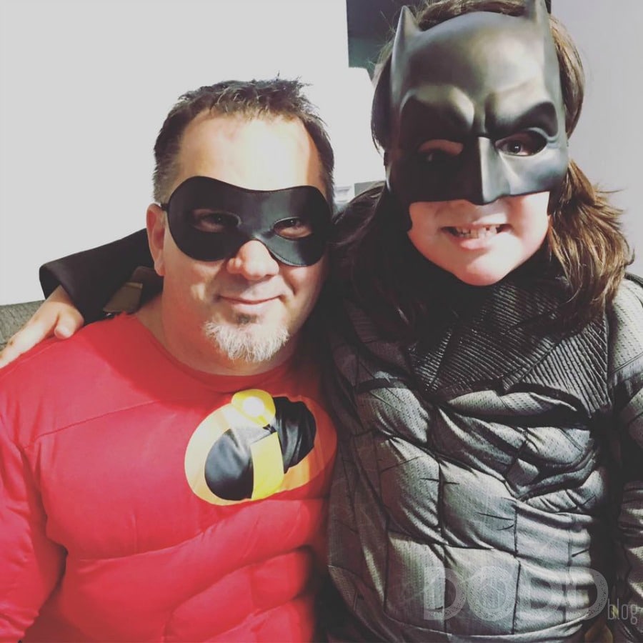 Father and daughter dressed up as Mr. Incredible and Batman