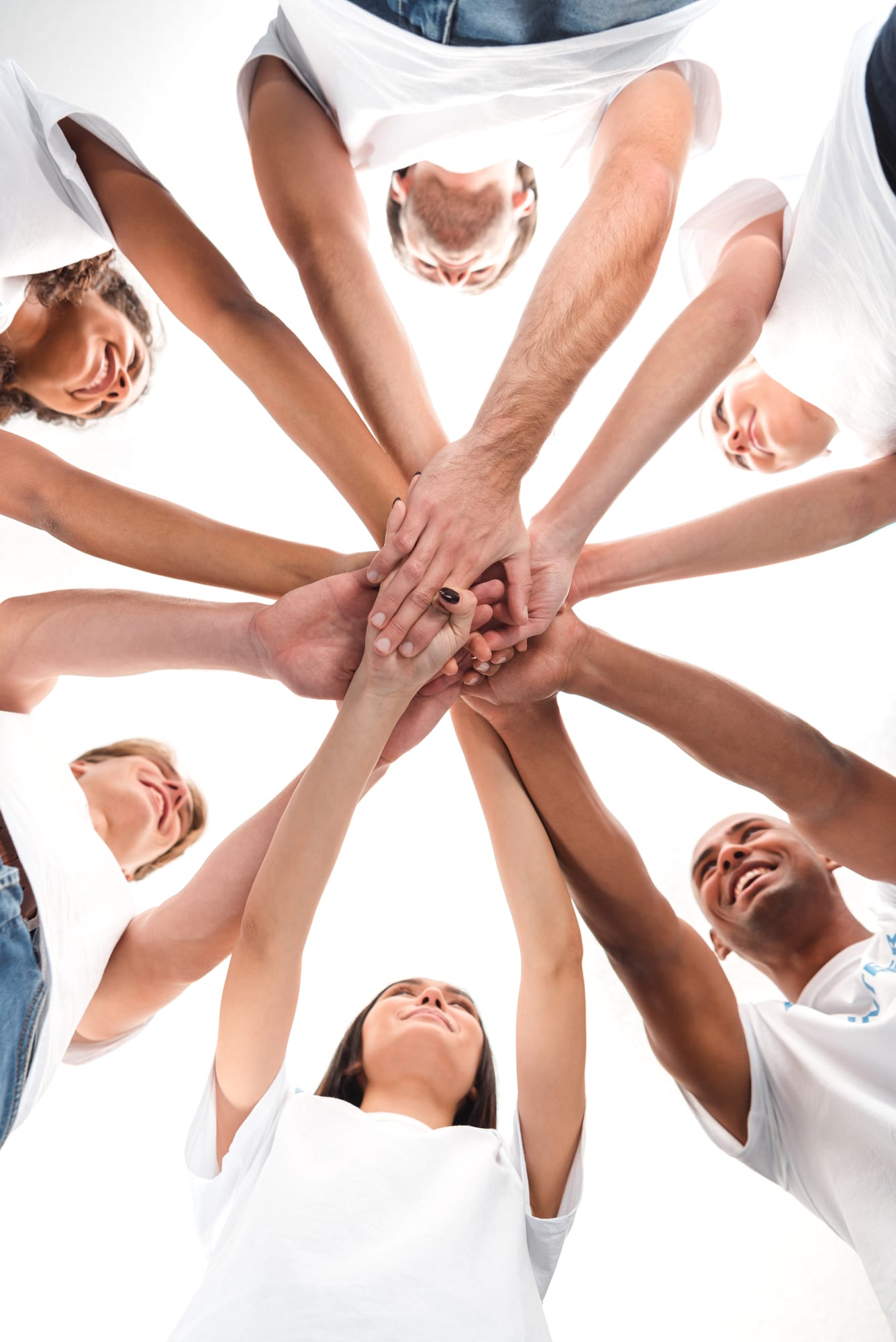 Male and female in a circle with hands in the middle. Team bulding. Team Sports