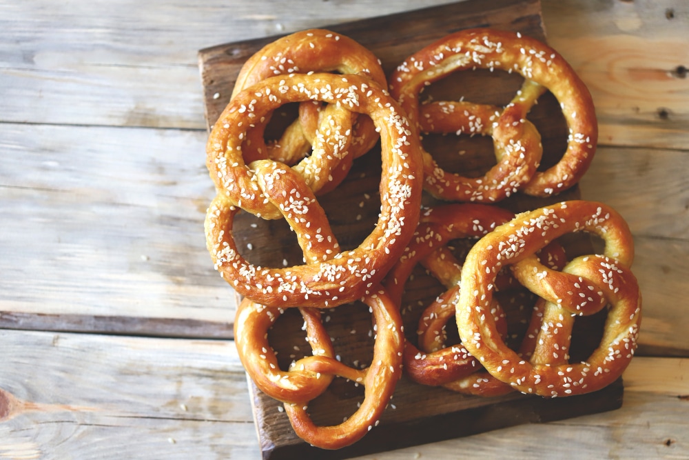 Fresh homemade pretzels on a wooden surface.