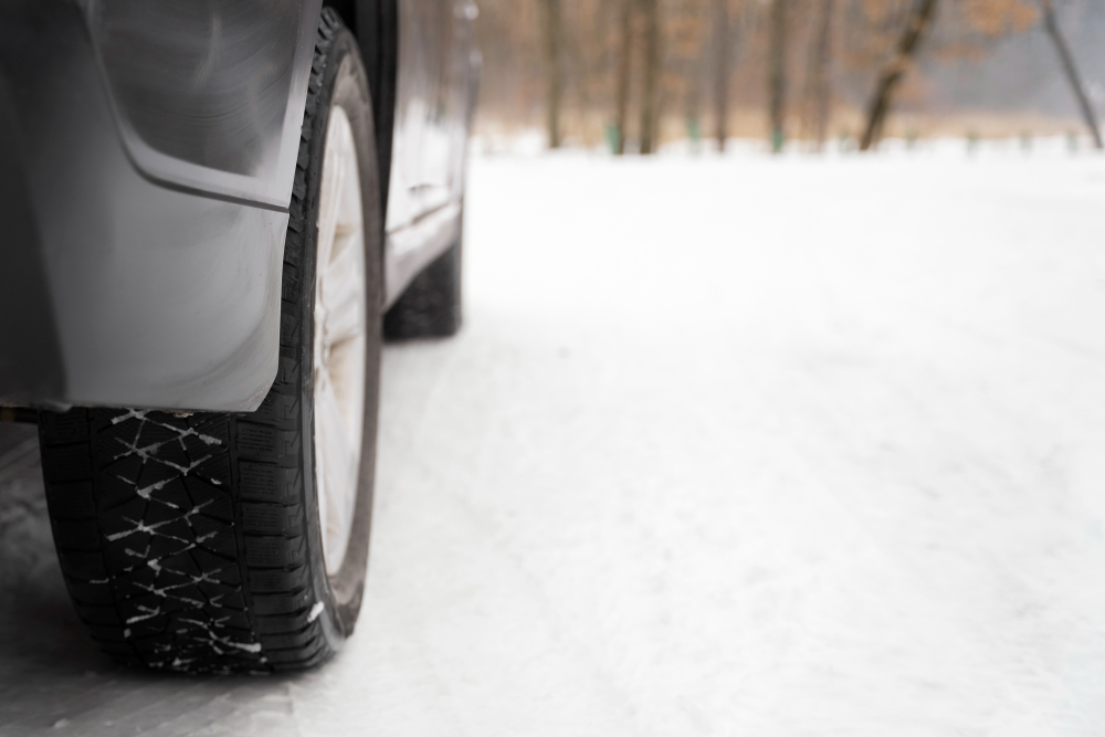 Close up on car tire during winter roadtrip