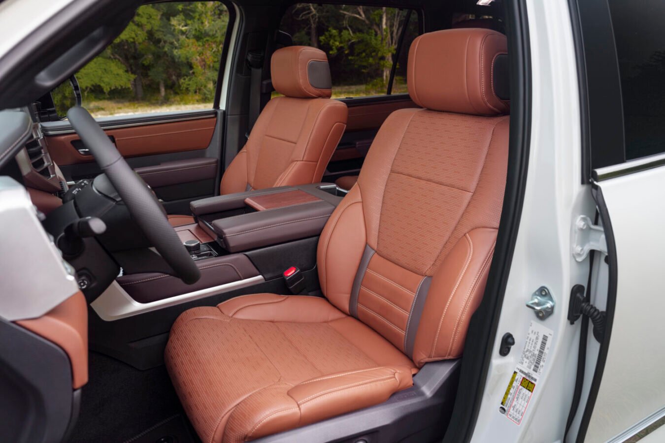 2025 Toyota Sequoia 1794 interior featuring premium leather seats, walnut wood trim, and a 14-inch touchscreen infotainment system.