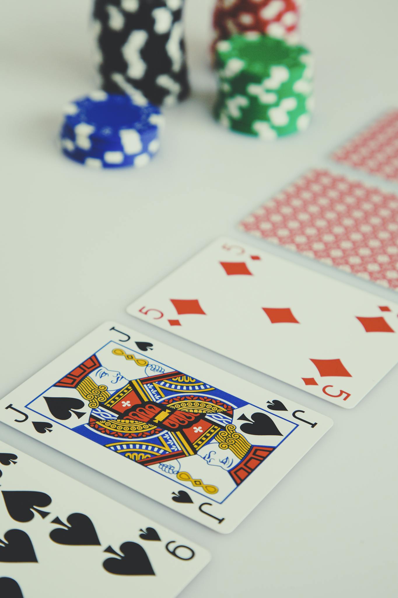 A detailed view of poker cards and chips depicting a strategic gambling setup.