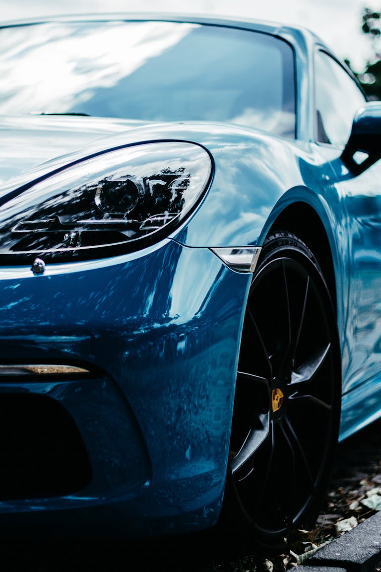 A detailed shot of a sleek blue sports car parked outdoors in Berlin, Germany.