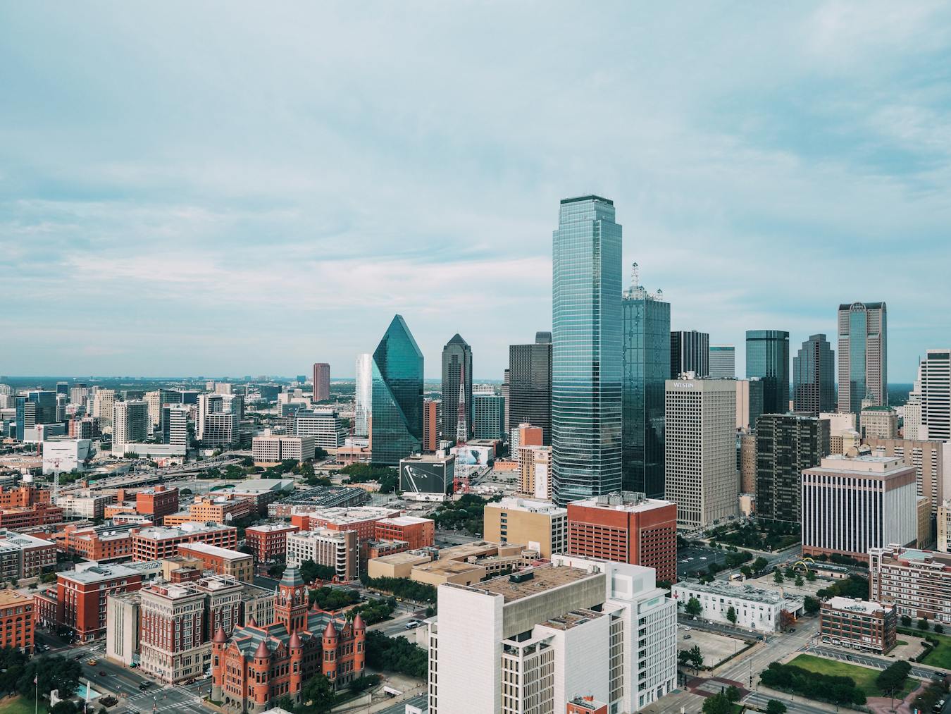 Aerial view of the vibrant Dallas skyline with iconic skyscrapers and urban landscape.